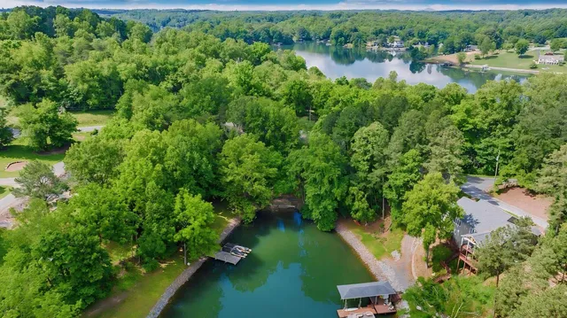 an aerial view of residential houses with outdoor space and trees