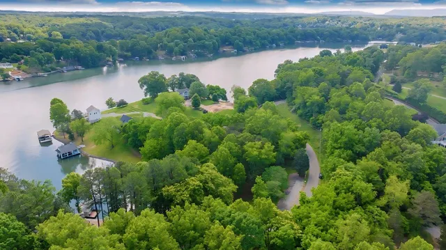 an aerial view of a houses with outdoor space and lake view
