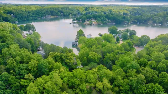 an aerial view of lake residential house with outdoor space and seating area