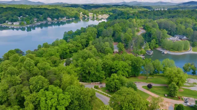 an aerial view of a houses with outdoor space and lake view