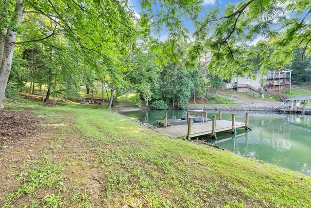 a view of a house with a yard and sitting area