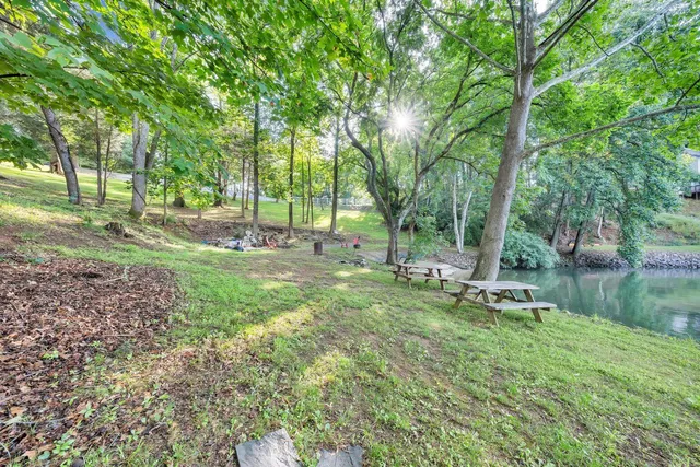 a backyard of a house with a yard and outdoor seating