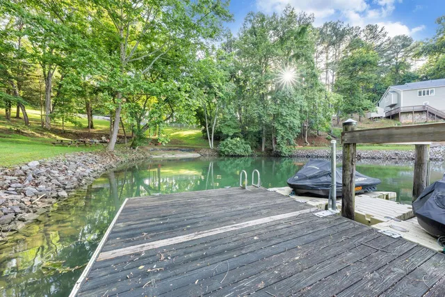 a patio with table and chairs next to a yard