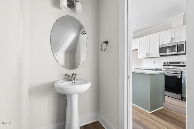 a kitchen with kitchen island a sink stainless steel appliances and cabinets
