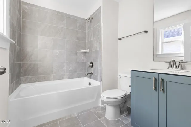 a white bath tub sitting next to a white toilet