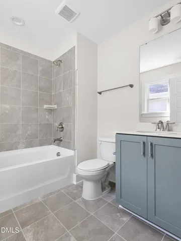 a bathroom with a bathtub toilet and sink