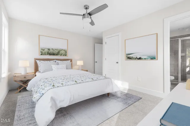 a bedroom with a large bed and a painting on the wall