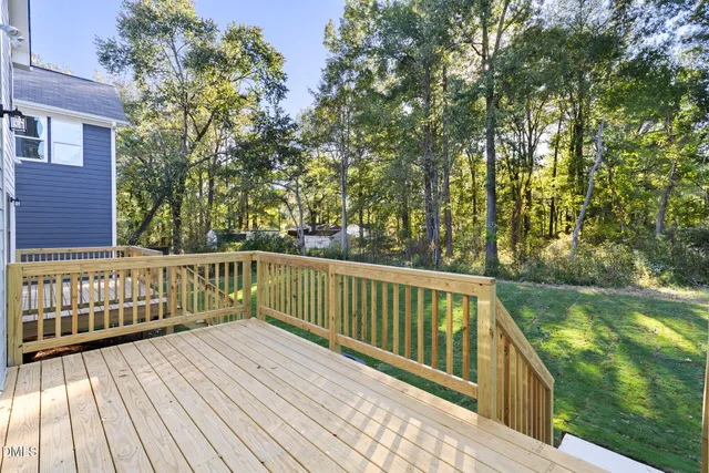 a view of balcony with wooden floor and fence