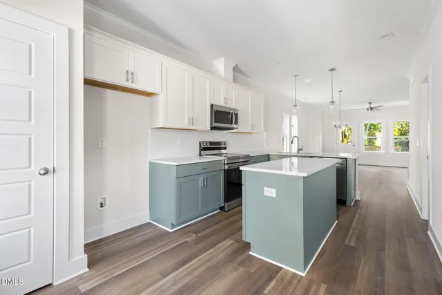 a kitchen with a sink a counter top space and stainless steel appliances