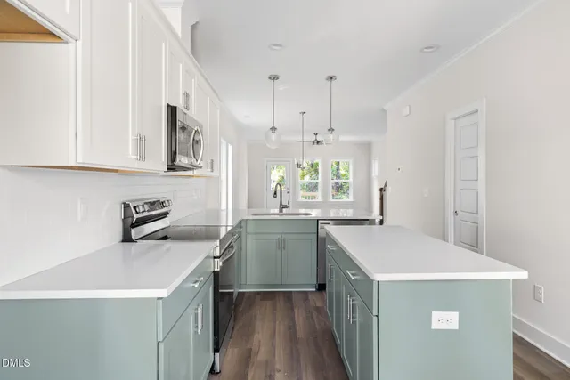 a kitchen that has a sink and a stove in it