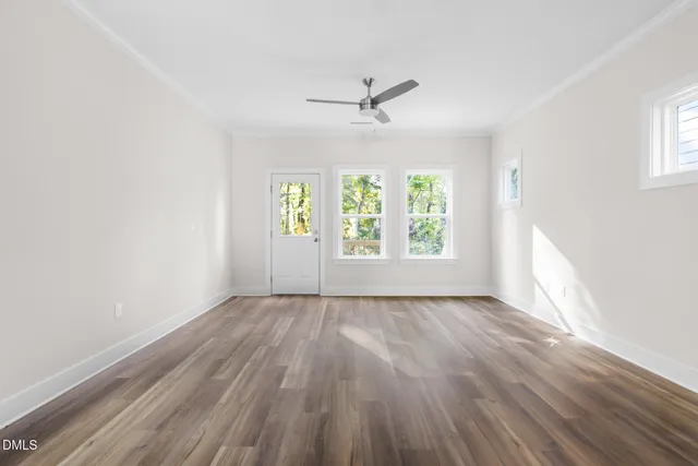 wooden floor in an empty room with a window