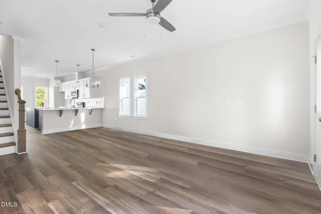 a view of a kitchen and an empty room