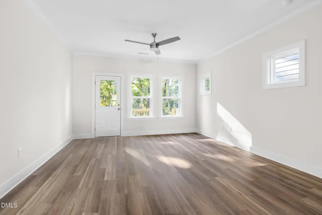 wooden floor in an empty room with a window