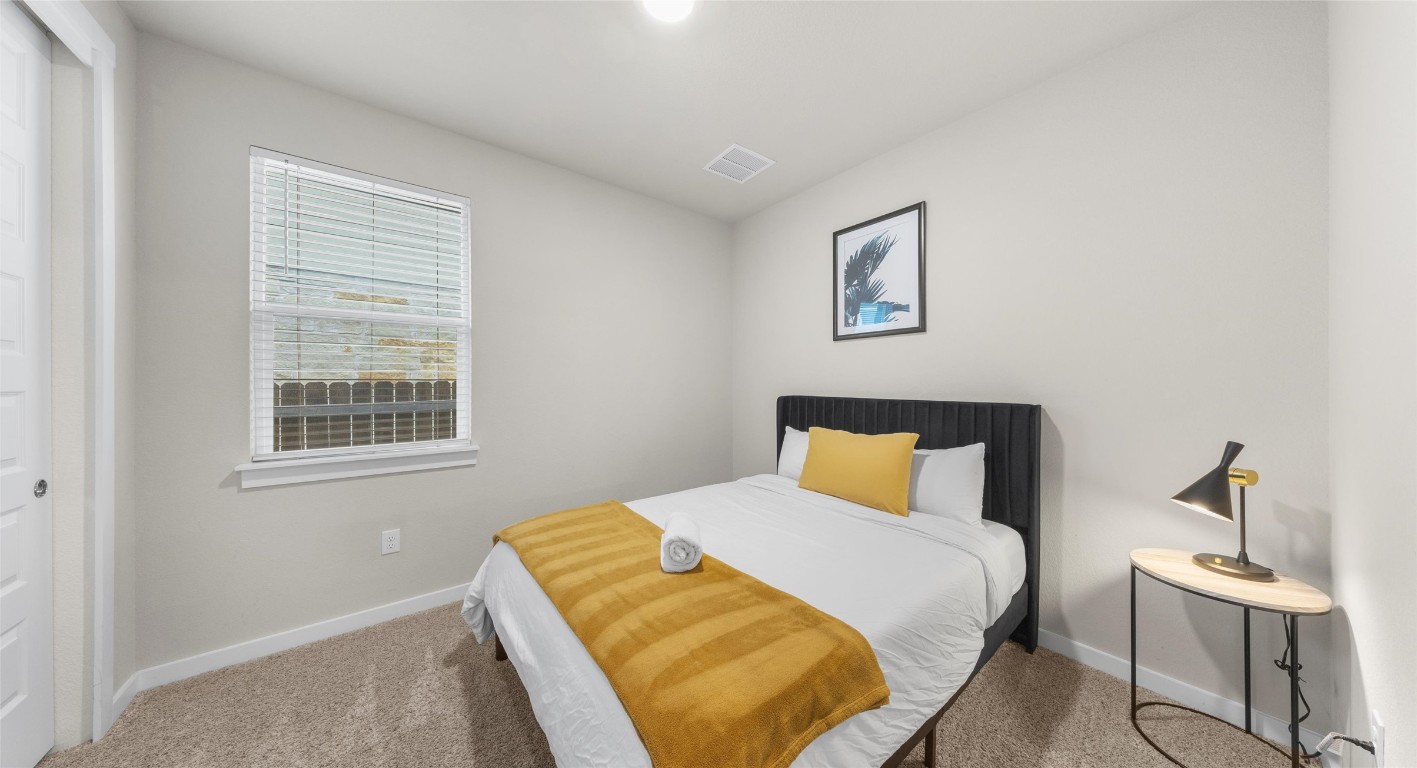 2416 Bear Cub Bend Leander, TX 78641 - Photo 11 of 24 a bedroom with a bed and wooden floor