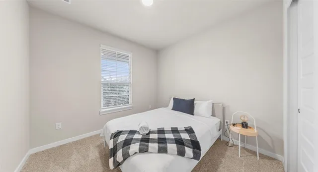 a bedroom with a bed and a window