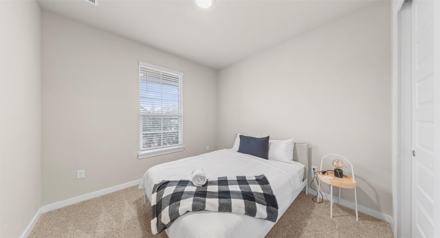 2416 Bear Cub Bend Leander, TX 78641 - Photo 12 of 24 a bedroom with a bed and a window