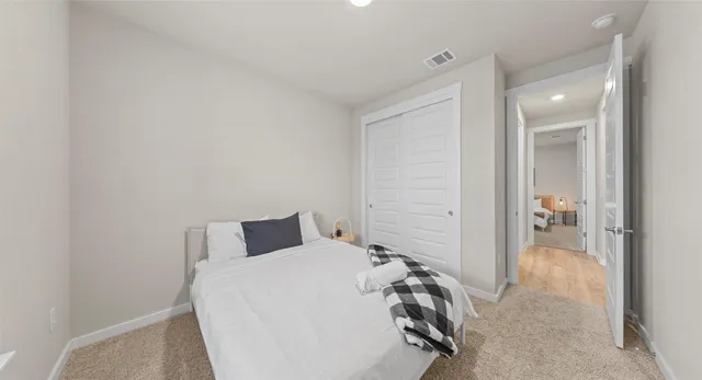 a bedroom with a bed and a view of bathroom