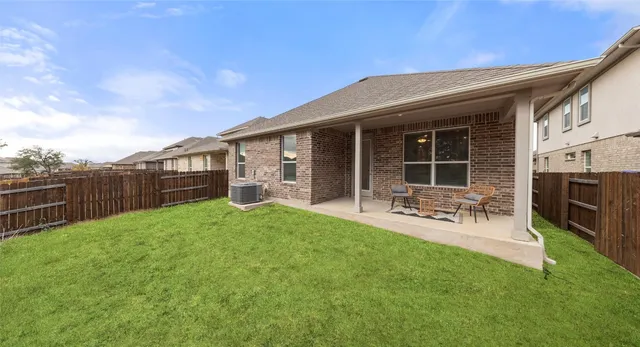 a view of a house with a backyard and a garden