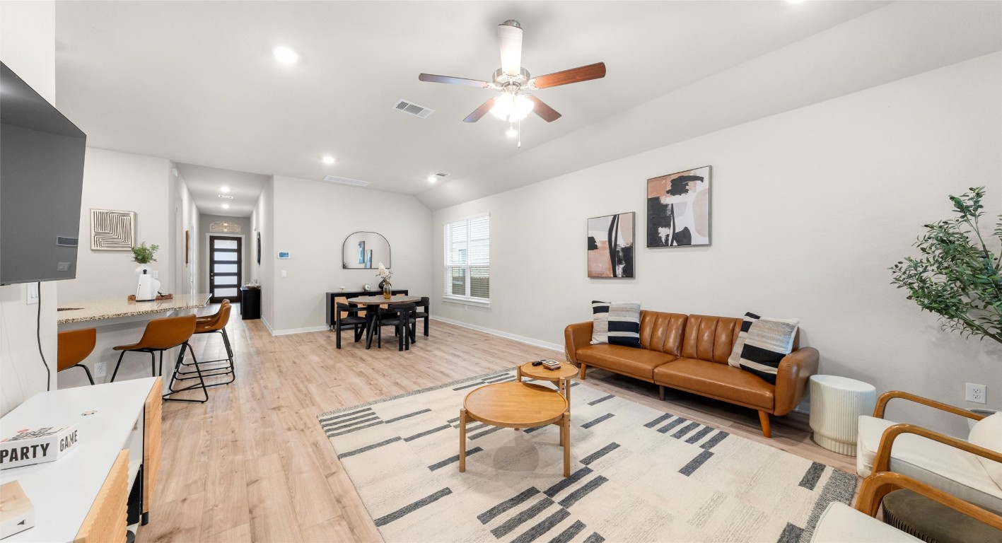 2416 Bear Cub Bend Leander, TX 78641 - Photo 2 of 24 a living room with furniture kitchen view and a chandelier