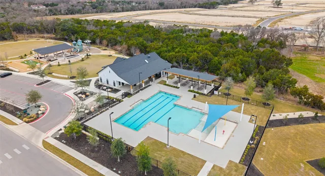 an aerial view of a house with a swimming pool