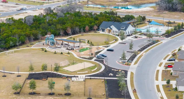 an aerial view of a swimming pool with outdoor seating