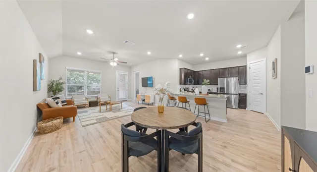 a large kitchen with a table and chairs