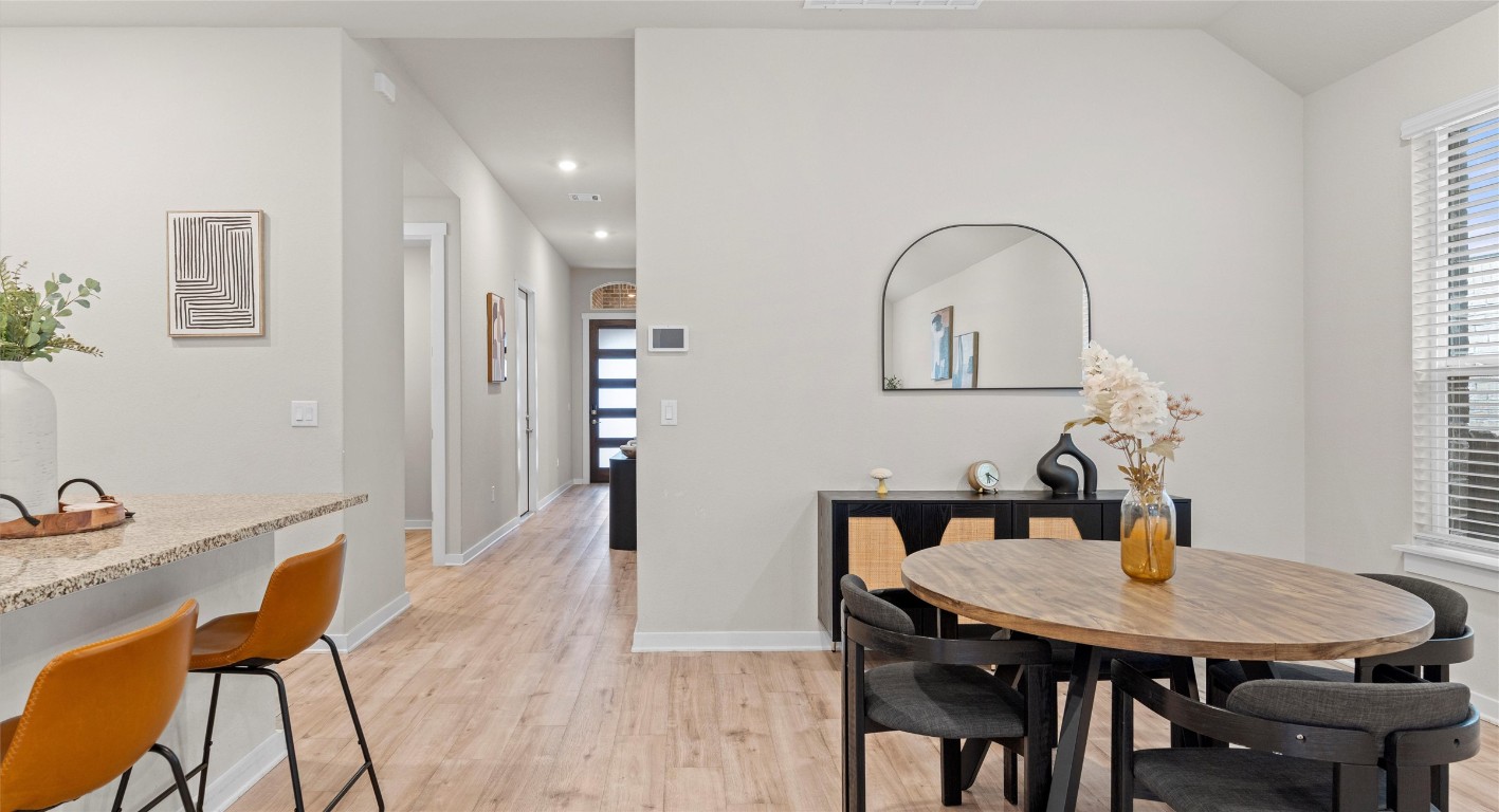 2416 Bear Cub Bend Leander, TX 78641 - Photo 4 of 24 a view of a dining room with furniture and wooden floor