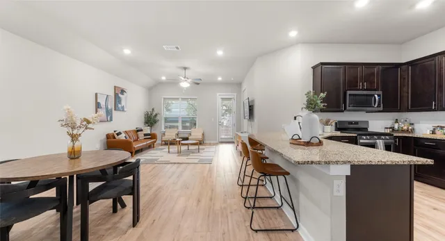 a view of a dining room with furniture and wooden floor