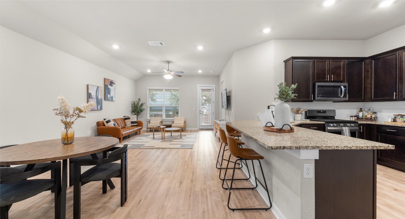 2416 Bear Cub Bend Leander, TX 78641 - Photo 5 of 24 a view of a dining room with furniture and wooden floor