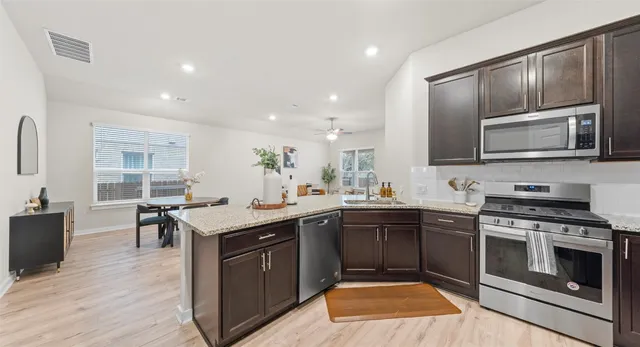 a kitchen with a sink stove and microwave