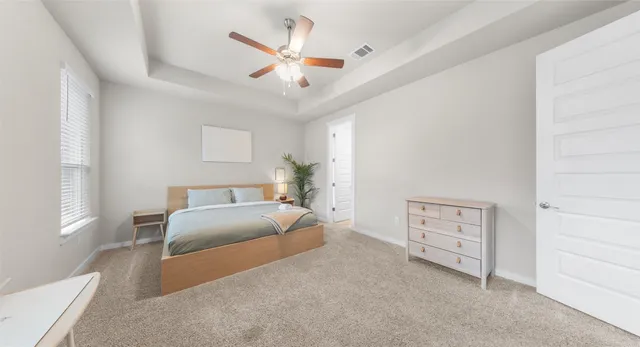 a bedroom with a bed chandelier and a window