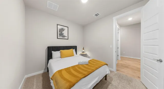 a bedroom with a bed and cupboard