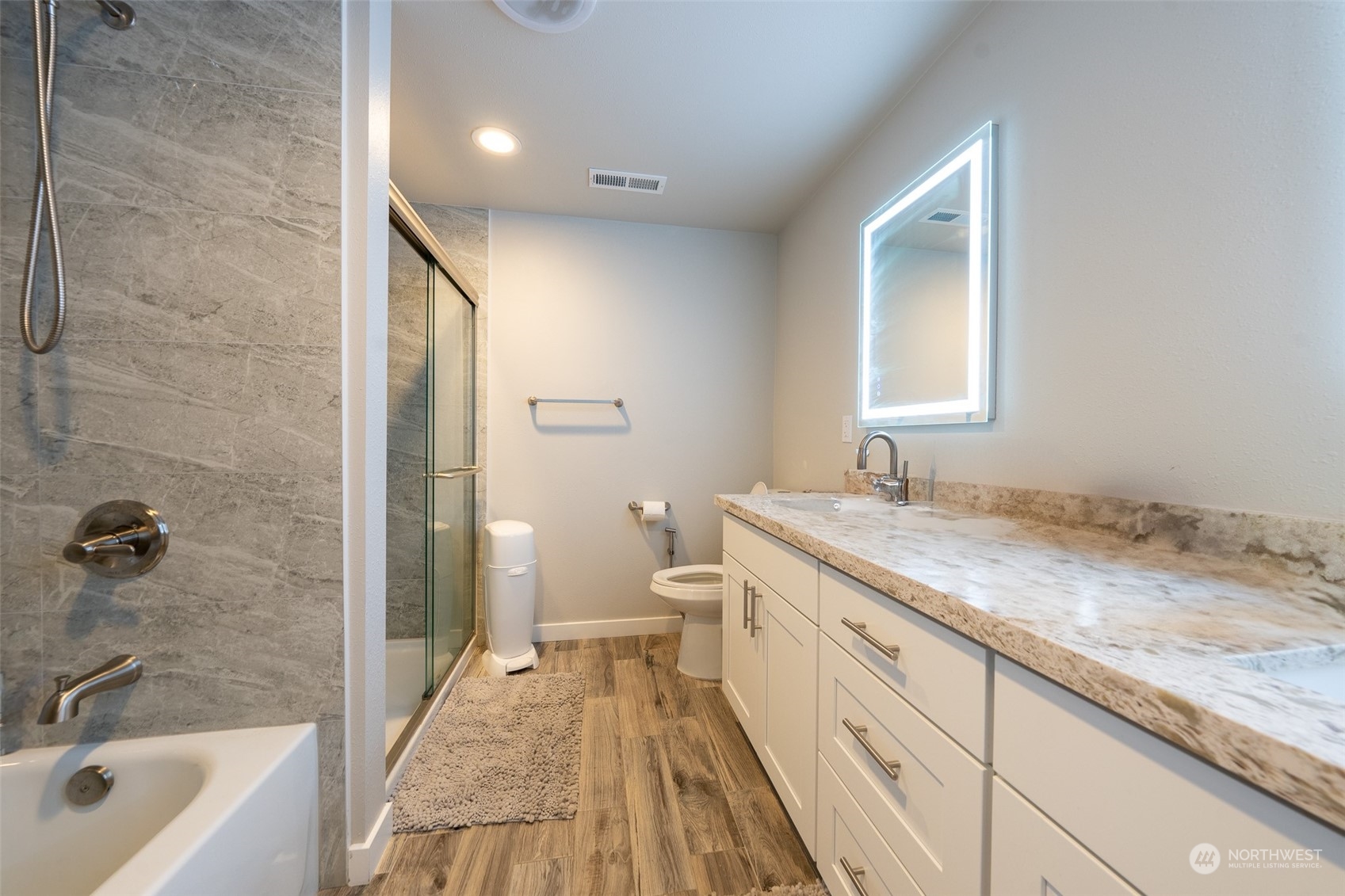 5515 South Bangor Street Seattle, WA 98178 - Photo 19 of 33 a bathroom with a granite countertop sink a toilet and shower