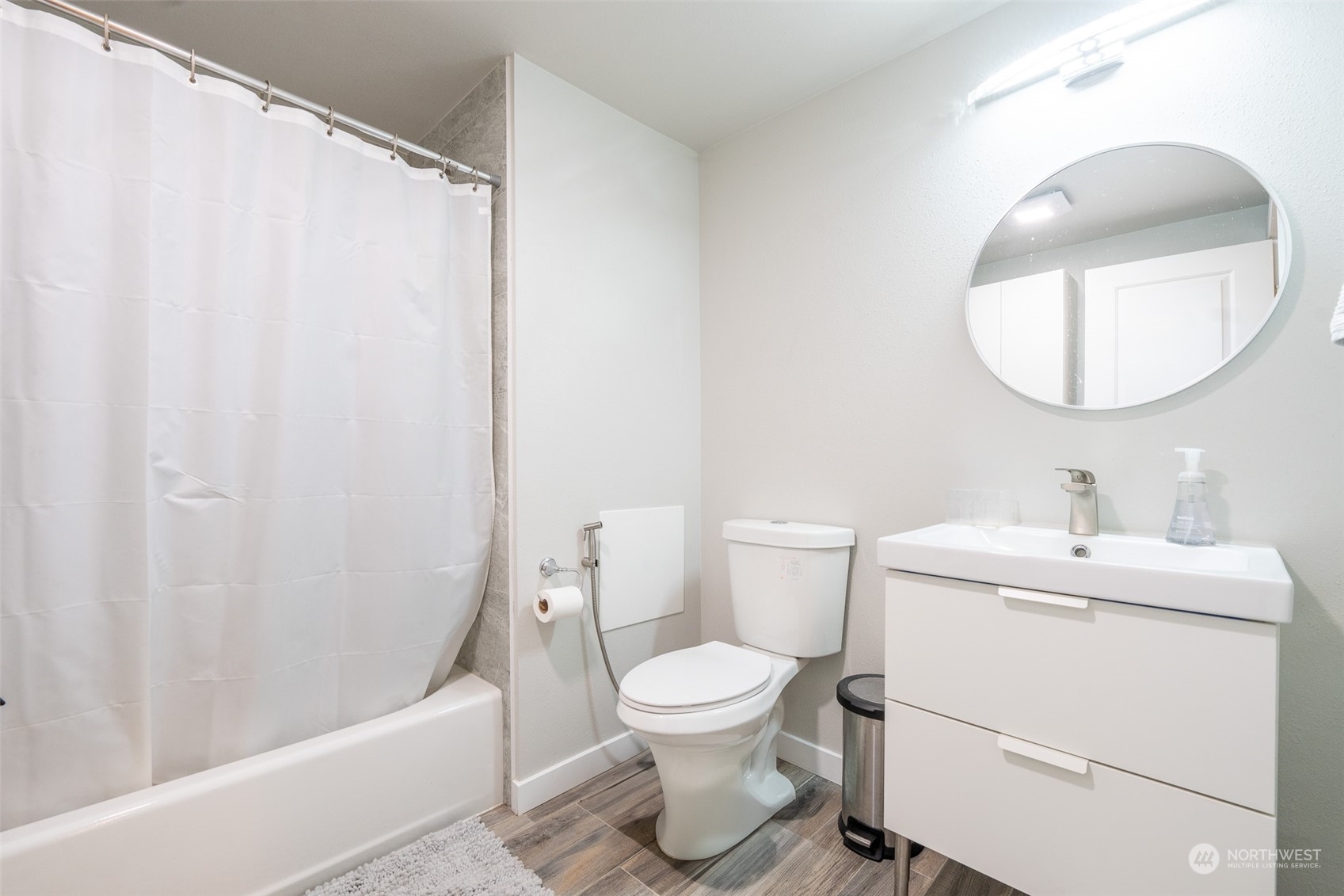 5515 South Bangor Street Seattle, WA 98178 - Photo 28 of 33 a bathroom with a toilet a sink and a mirror