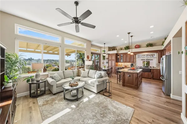 a living room with lots of furniture and a large window
