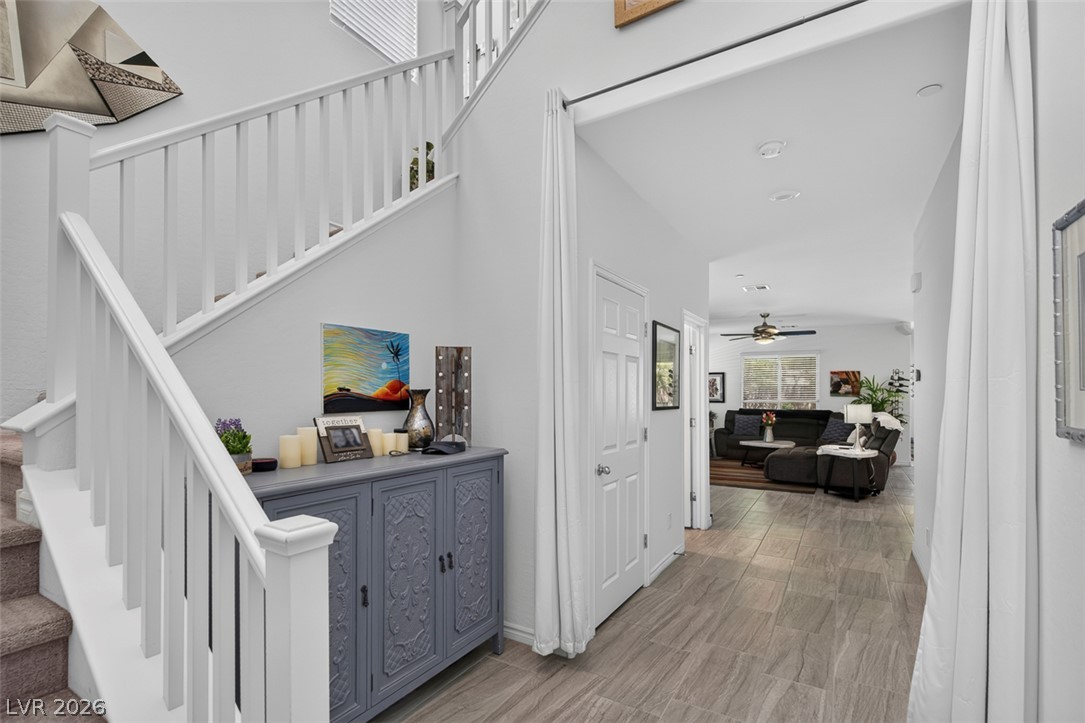 1824 Redland Ridge Street Henderson, NV 89002 - Photo 6 of 69 A welcoming entryway with a grand staircase and durable tiled flooring leads to comfortable living spaces.
