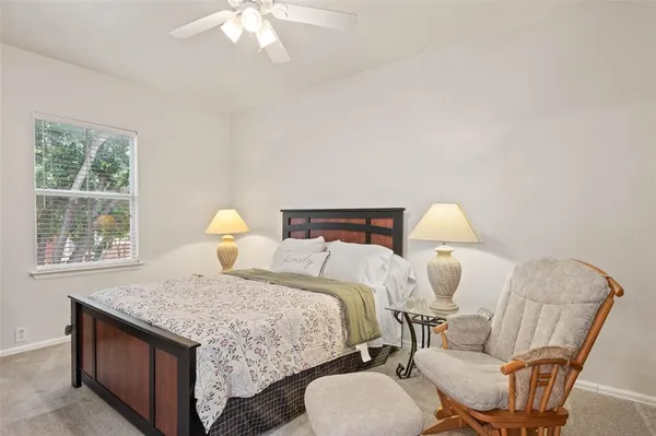 a bedroom with a bed and lamp