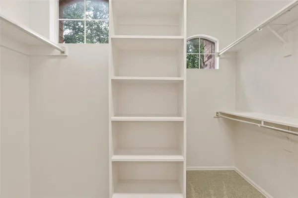 a view of storage and utility room with windows
