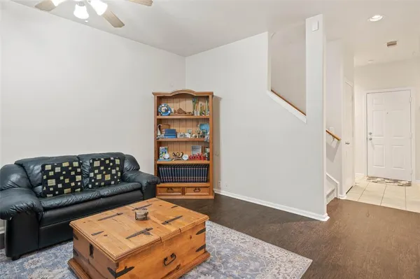 a dining room with furniture a rug and wooden floor