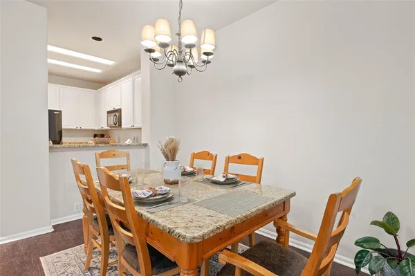 a dining room with furniture and chandelier