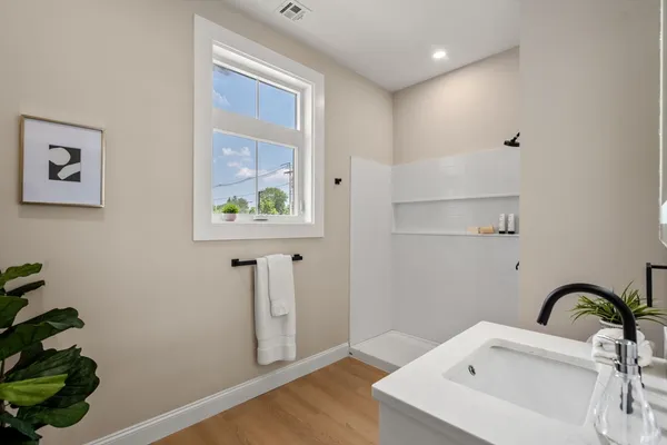 a bathroom with a sink and a window
