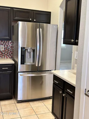 a kitchen with stainless steel appliances granite countertop a refrigerator and a stove
