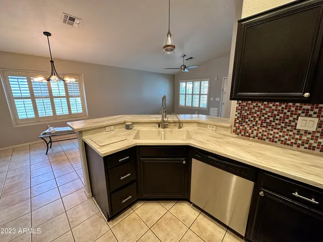 a kitchen with a sink stove and cabinets
