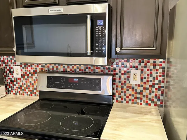 a kitchen with a stove and a microwave