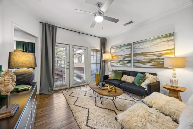 a living room with furniture and wooden floor