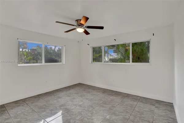 a view of a livingroom with a ceiling fan and window