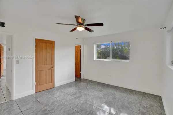 a view of entryway and hall with a ceiling fan