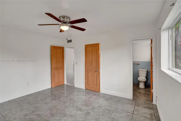 a view of a livingroom with a ceiling fan and window