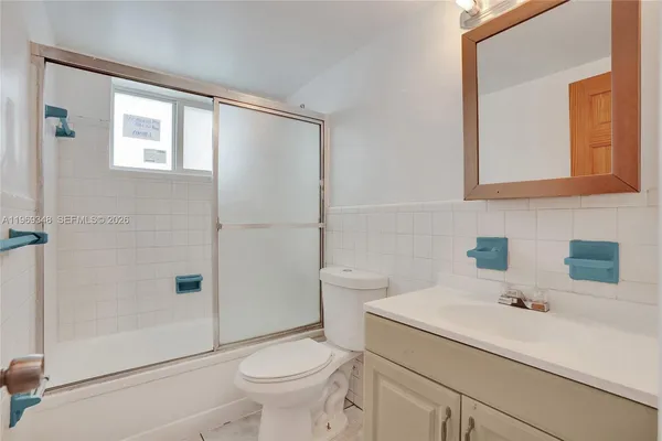 a bathroom with a sink toilet and mirror