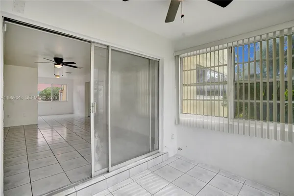 a view of room with a ceiling fan and a window